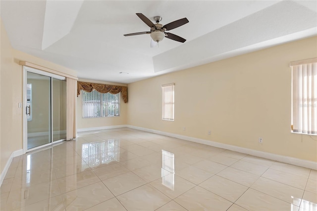 tiled empty room featuring ceiling fan