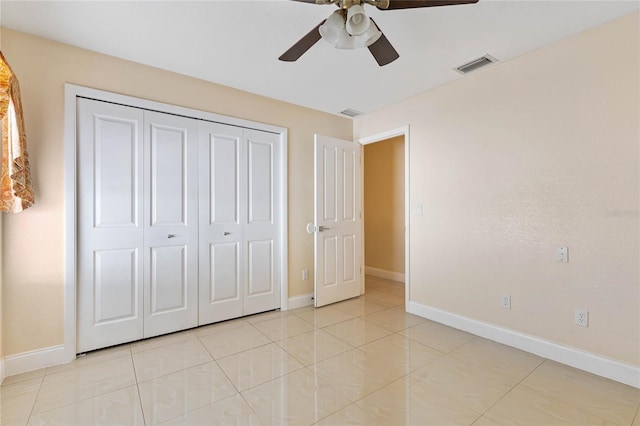 unfurnished bedroom with a closet, ceiling fan, and light tile patterned flooring