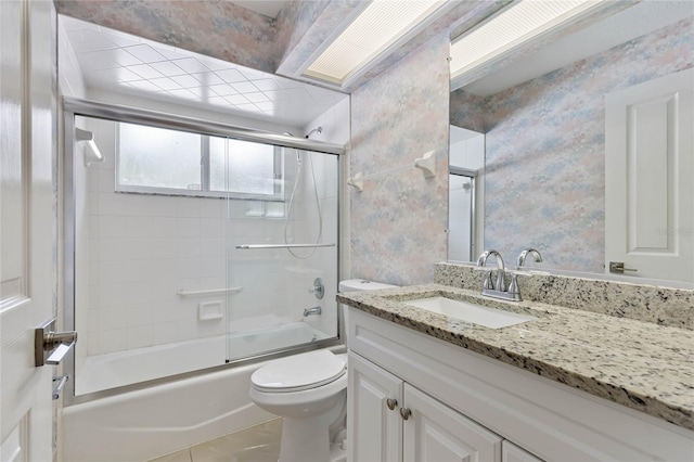 full bathroom featuring tile patterned flooring, vanity, toilet, and enclosed tub / shower combo