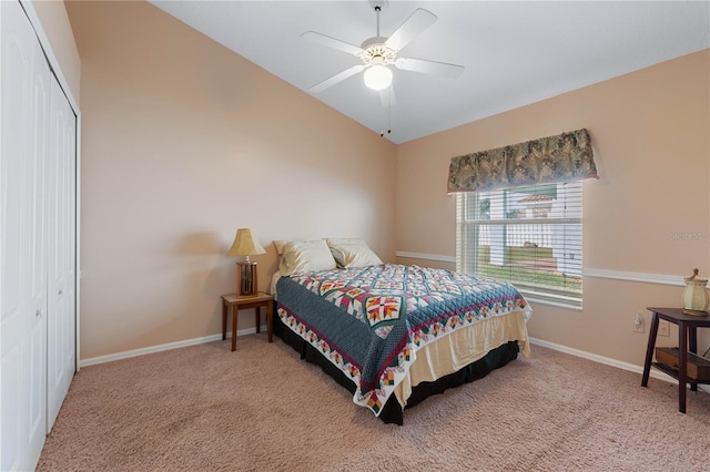 bedroom with carpet flooring, ceiling fan, vaulted ceiling, and a closet