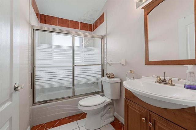 full bathroom with tile patterned floors, toilet, vanity, and combined bath / shower with glass door