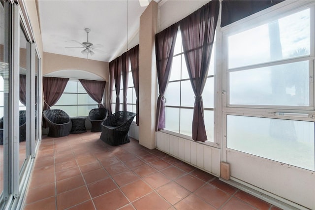 sunroom / solarium featuring ceiling fan