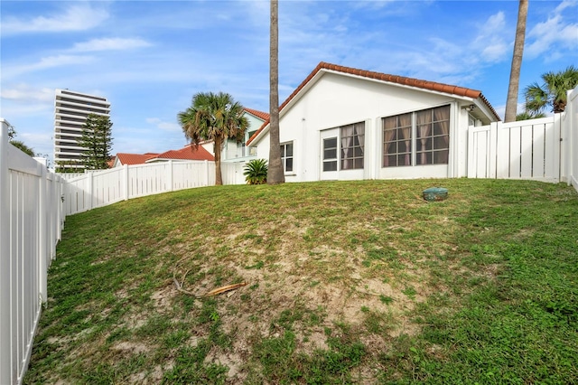 rear view of property featuring a lawn