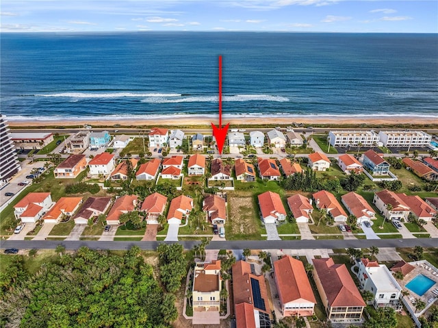 drone / aerial view with a water view and a view of the beach