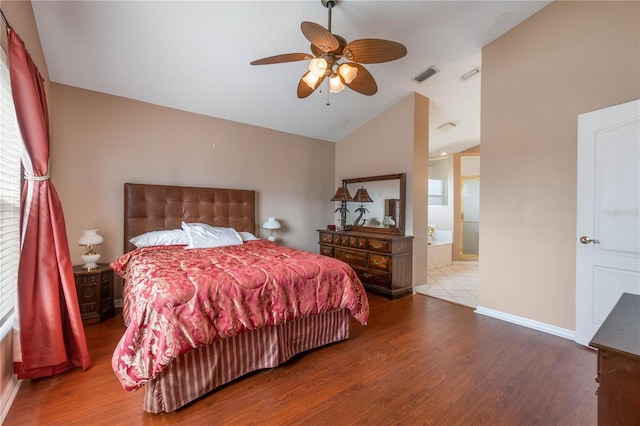 bedroom featuring multiple windows, hardwood / wood-style flooring, vaulted ceiling, and ceiling fan