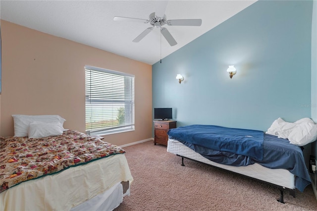 carpeted bedroom with ceiling fan and vaulted ceiling