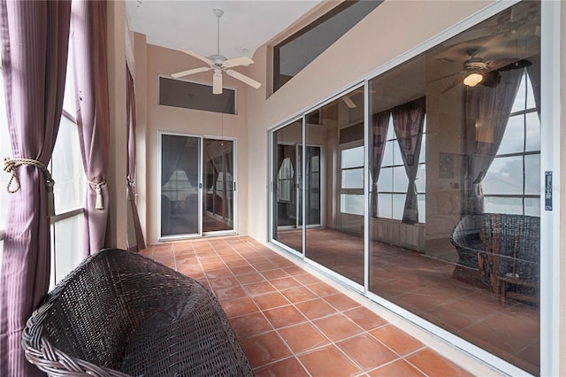 sunroom with ceiling fan and lofted ceiling