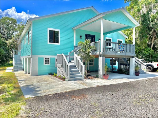 raised beach house featuring a porch