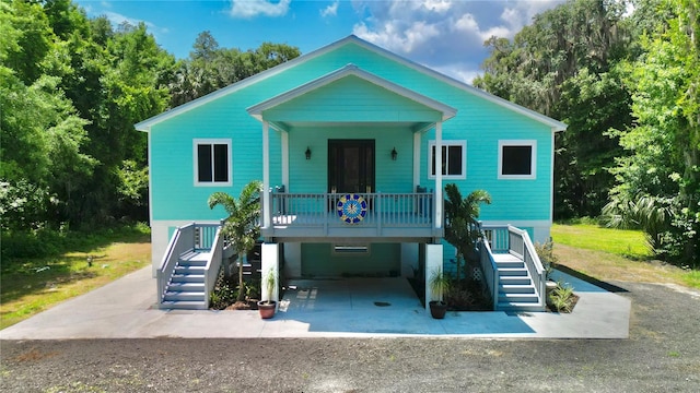 beach home featuring a carport and covered porch