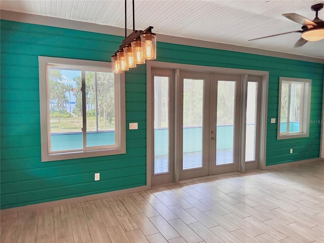 doorway with ceiling fan, plenty of natural light, french doors, and light hardwood / wood-style flooring