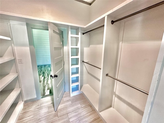 spacious closet featuring light hardwood / wood-style flooring