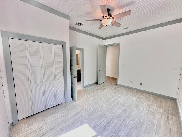 unfurnished bedroom featuring wooden ceiling, ceiling fan, light wood-type flooring, and a closet