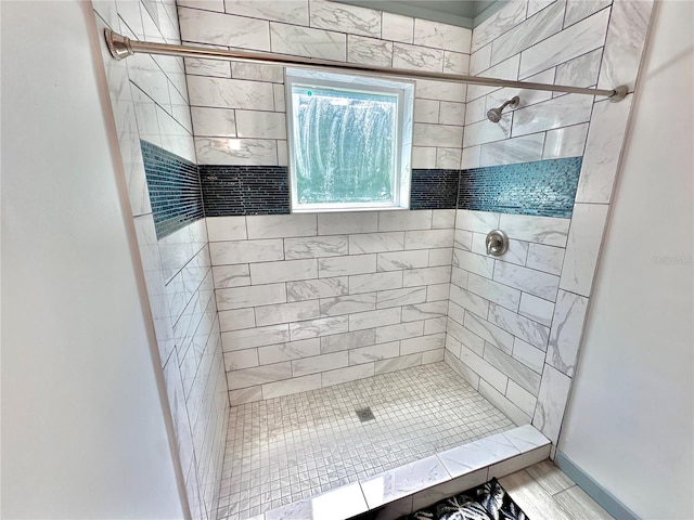 bathroom with a tile shower