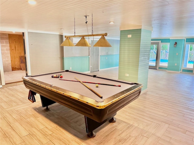 rec room with wooden walls, light hardwood / wood-style floors, and billiards