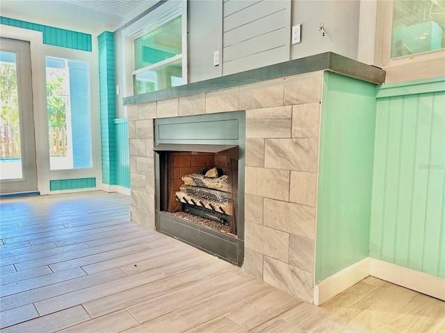 room details featuring hardwood / wood-style flooring and a tile fireplace