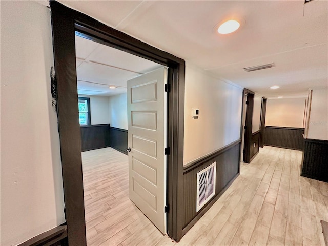 corridor with light hardwood / wood-style floors