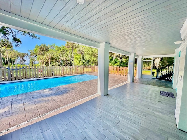 view of pool with a patio and a wooden deck