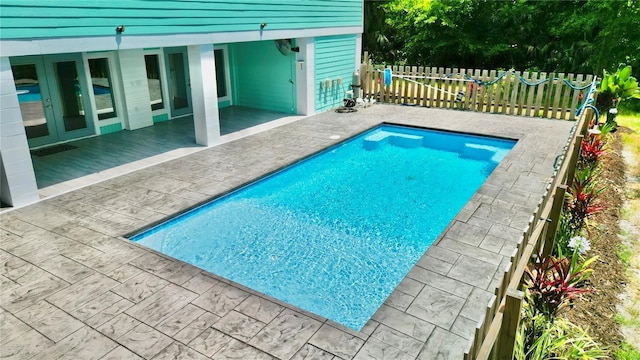 view of pool with french doors and a patio area