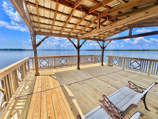 dock area featuring a deck with water view