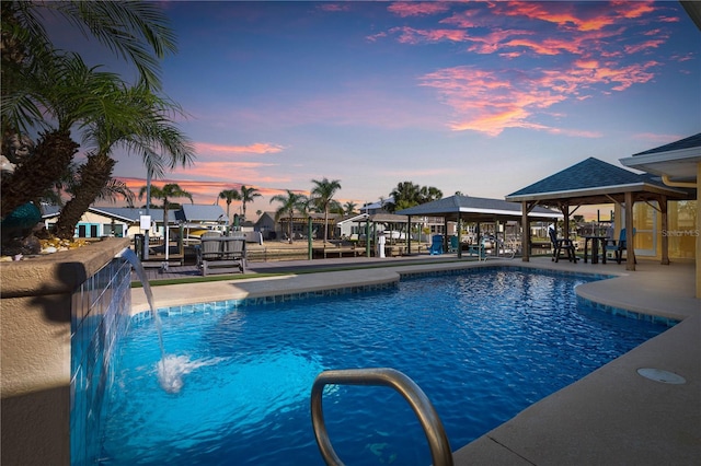 pool at dusk with pool water feature