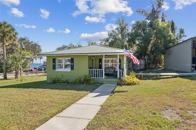 bungalow-style home with a porch and a front lawn