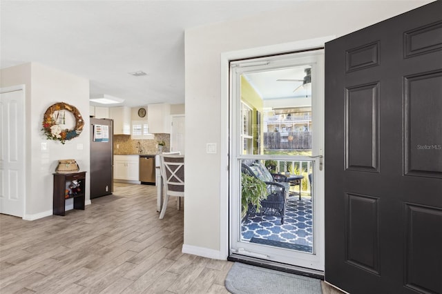 entrance foyer featuring ceiling fan and light wood-type flooring