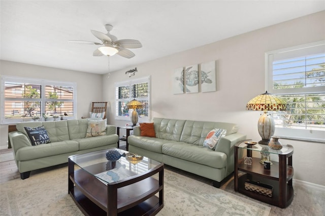 living room featuring plenty of natural light and ceiling fan