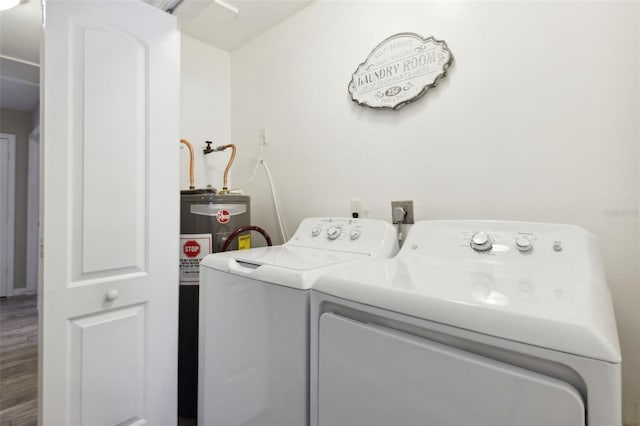 clothes washing area featuring hardwood / wood-style floors and washer and dryer