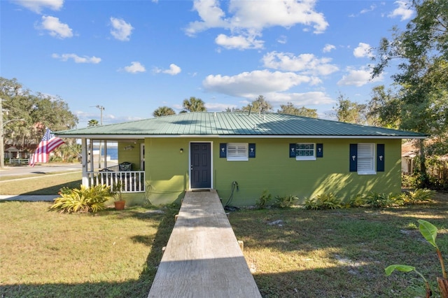 view of front of property with covered porch and a front yard