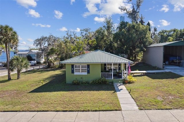 view of front of home with a carport, covered porch, and a front lawn