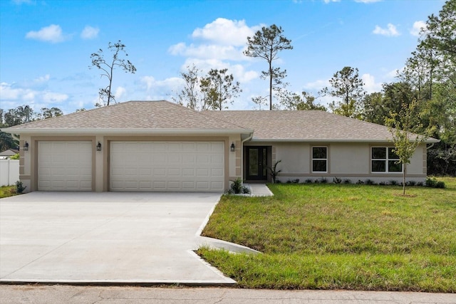 ranch-style house featuring a garage and a front lawn