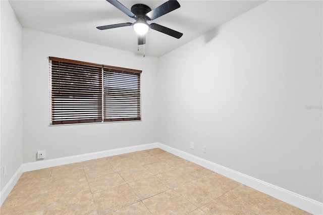 tiled spare room featuring ceiling fan