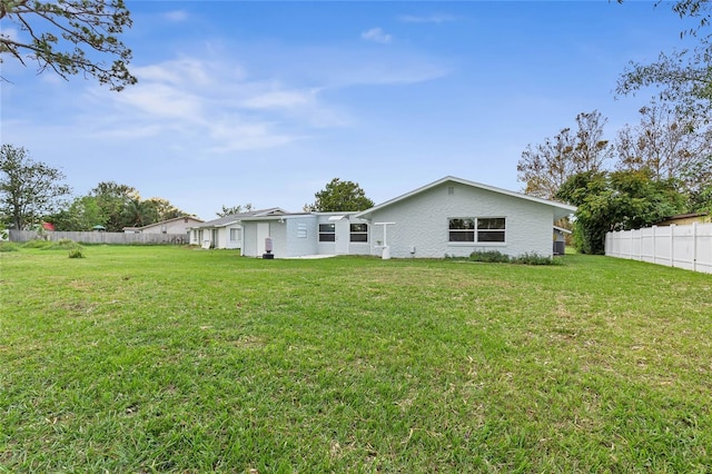 back of property featuring a lawn