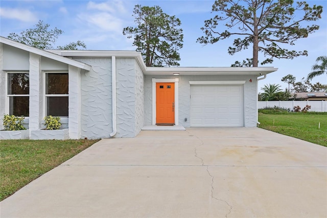 single story home featuring a front yard and a garage