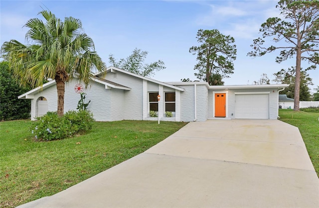 ranch-style house featuring a garage and a front lawn