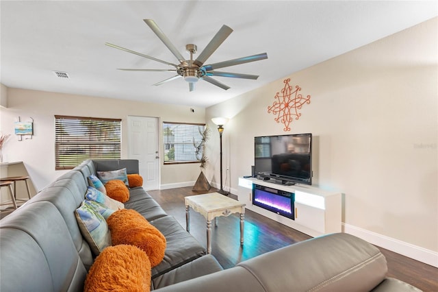 living room featuring dark hardwood / wood-style floors and ceiling fan