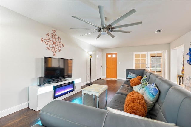 living room with ceiling fan, dark hardwood / wood-style flooring, and french doors