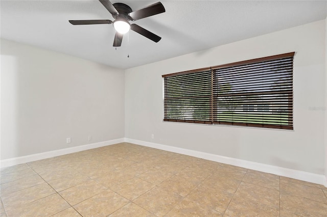 spare room featuring ceiling fan and light tile patterned floors