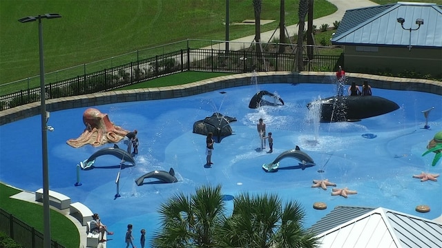 view of swimming pool with pool water feature