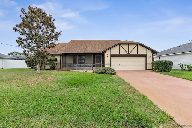 view of front of home with a garage, a front lawn, and a sunroom