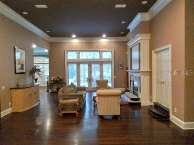 living room with crown molding, french doors, and dark hardwood / wood-style floors