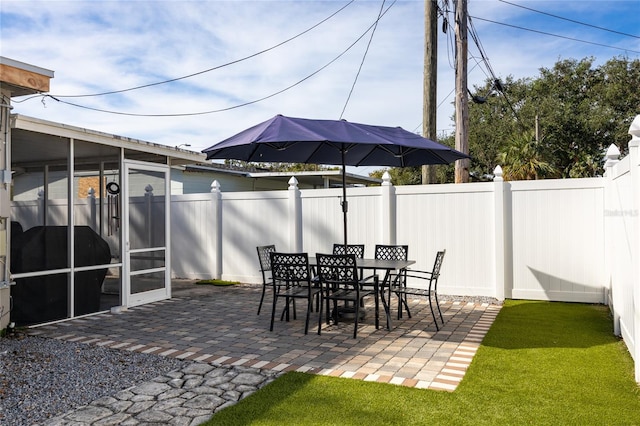 view of patio / terrace featuring a sunroom