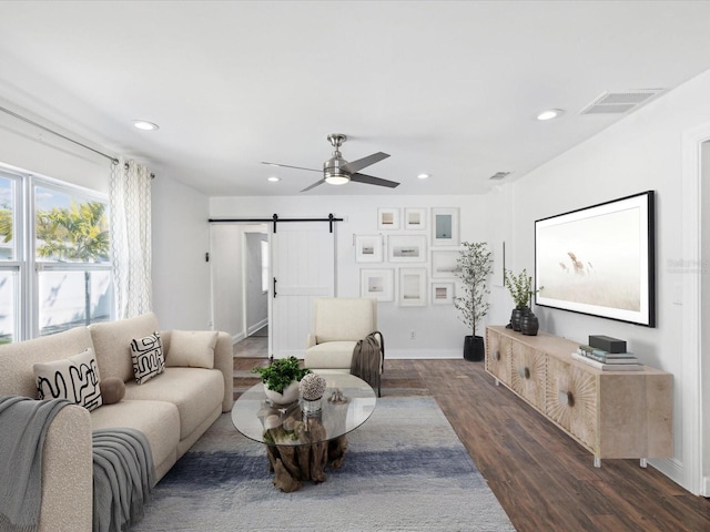 living room featuring visible vents, a ceiling fan, dark wood-style floors, recessed lighting, and a barn door