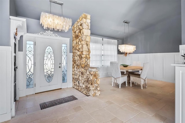 entryway featuring a healthy amount of sunlight and an inviting chandelier