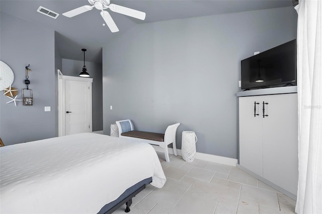 bedroom featuring ceiling fan, light tile patterned floors, and vaulted ceiling