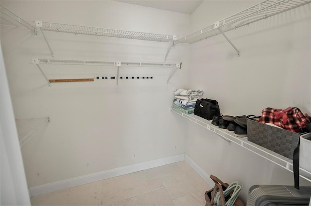 walk in closet featuring light tile patterned floors