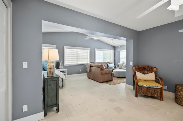 living room featuring ceiling fan and lofted ceiling