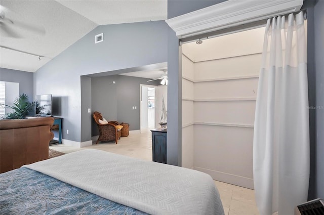 bedroom featuring light tile patterned floors, ceiling fan, and lofted ceiling