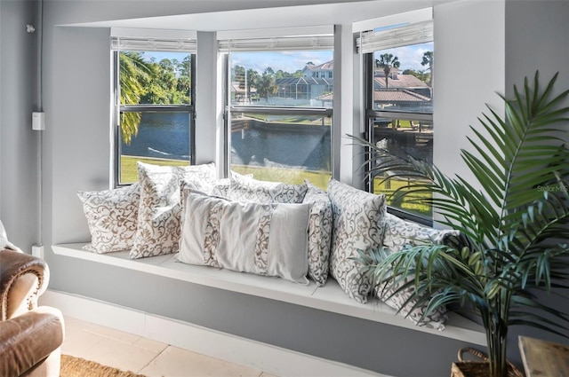 interior space with a water view and tile patterned floors