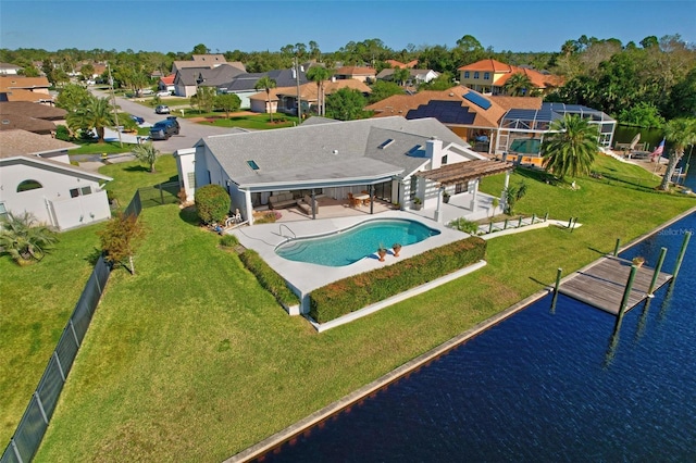 view of swimming pool featuring a yard, a patio, and a water view